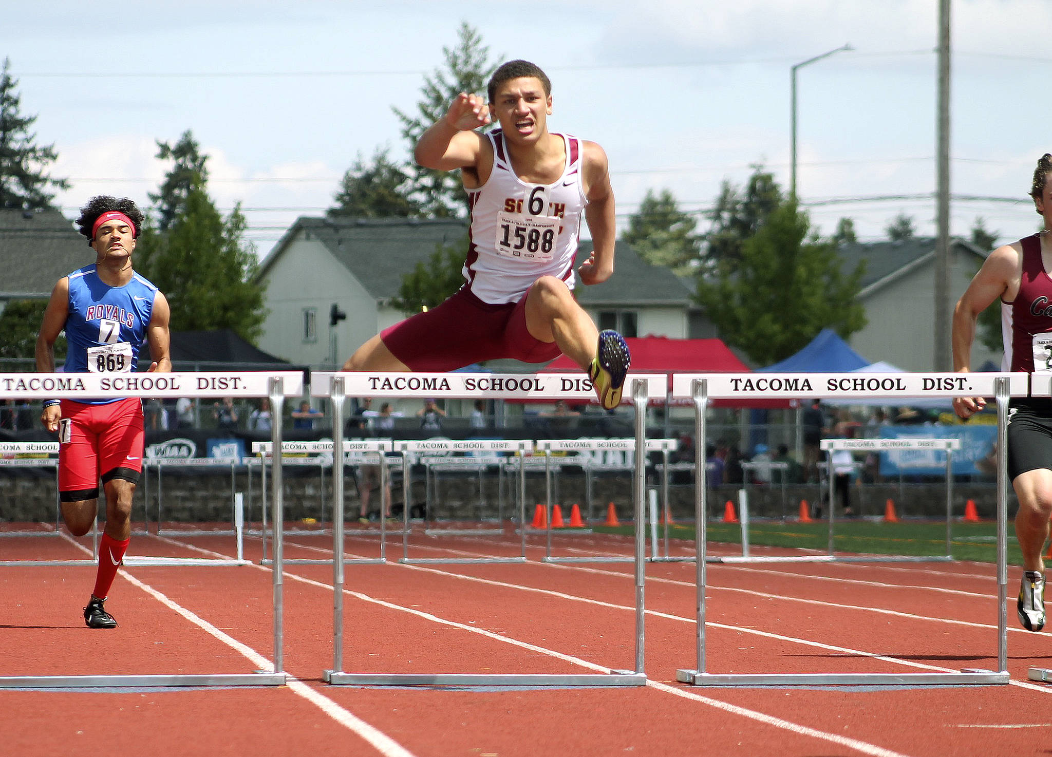 Deyondre Davis clears the final hurdle in the 300-meter event. He took third in that race and second in the 110-meter hurdles. (Mark Krulish | Kitsap Daily News photo)