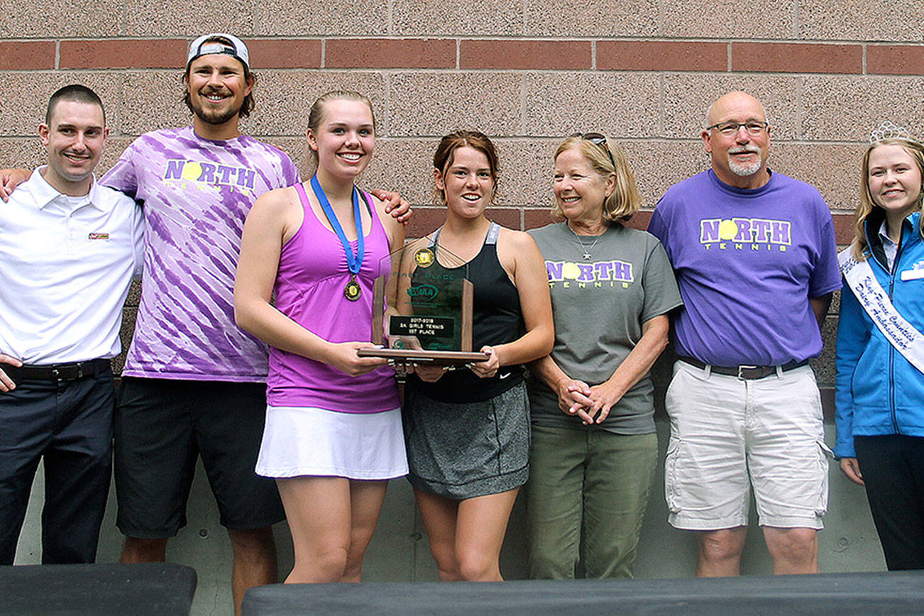 North Kitsap’s Danya Wallis became the first Kitsap tennis player to win four state championships. Here she shares North Kitsap’s team title with teammate Anna Bronchal and head coach Jordan Prince. (Jacob Moore/Kitsap News Group)