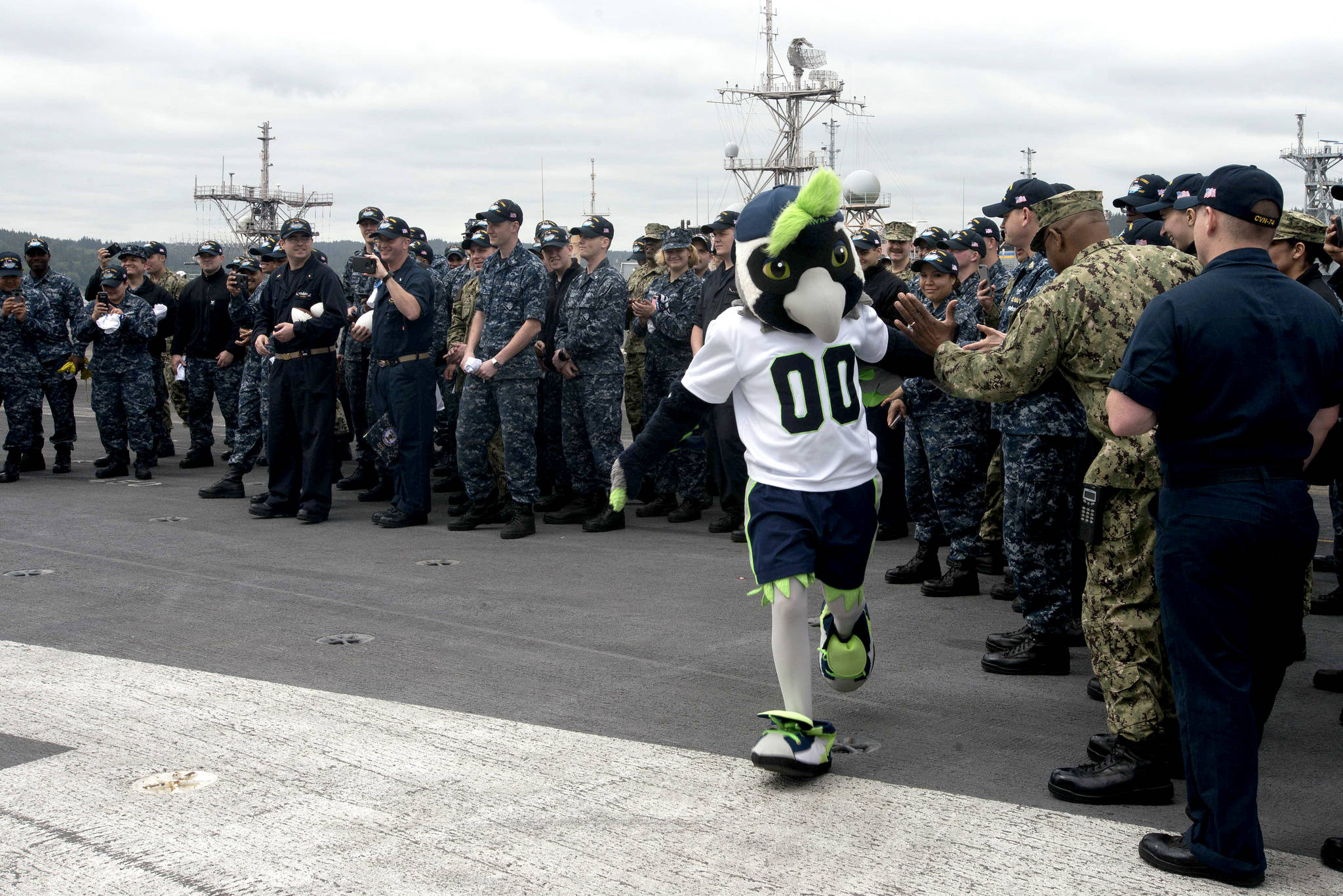 The Seattle Seahawks football team mascot, Boom, greets Sailors aboard the aircraft carrier USS John C. Stennis (CVN 74). Stennis is pier-side after returning to homeport after the completion of a seven-week underway where the ship’s crew completed TSTA/FEP early and Carrier Strike Group 3 Group Sail in preparation for its next scheduled deployment.                                Mass Communication Specialist Seaman Isabel Birchard / U.S. Navy