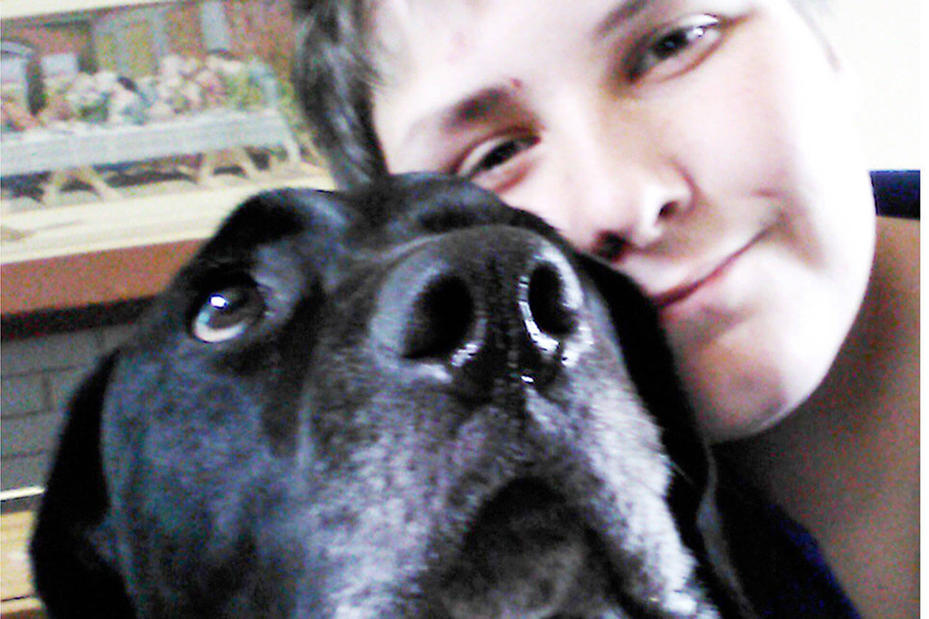 Dakota Braun, 14, is happily reunited with his dog Mowgli thanks to staff members at Kitsap Humane Society, who checked the canine’s pet license. (Kitsap Daily News photo)