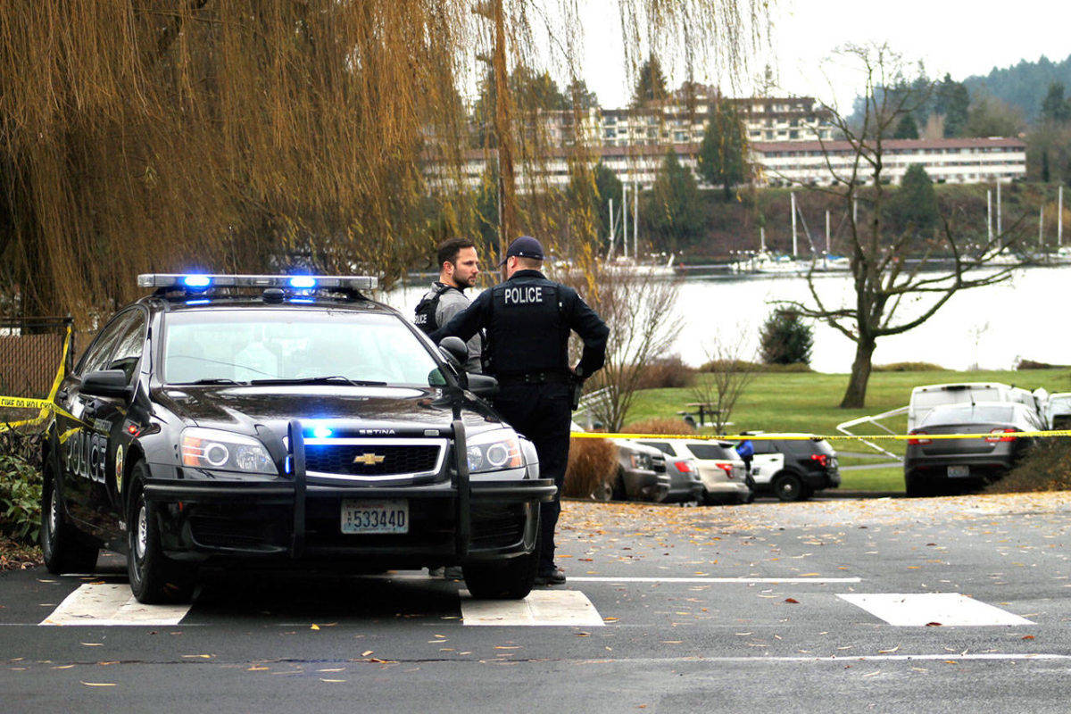 Bremerton police officers consult near the scene of an officer-involved shooting Dec. 17.                                Nick Twietmeyer / Kitsap News Group