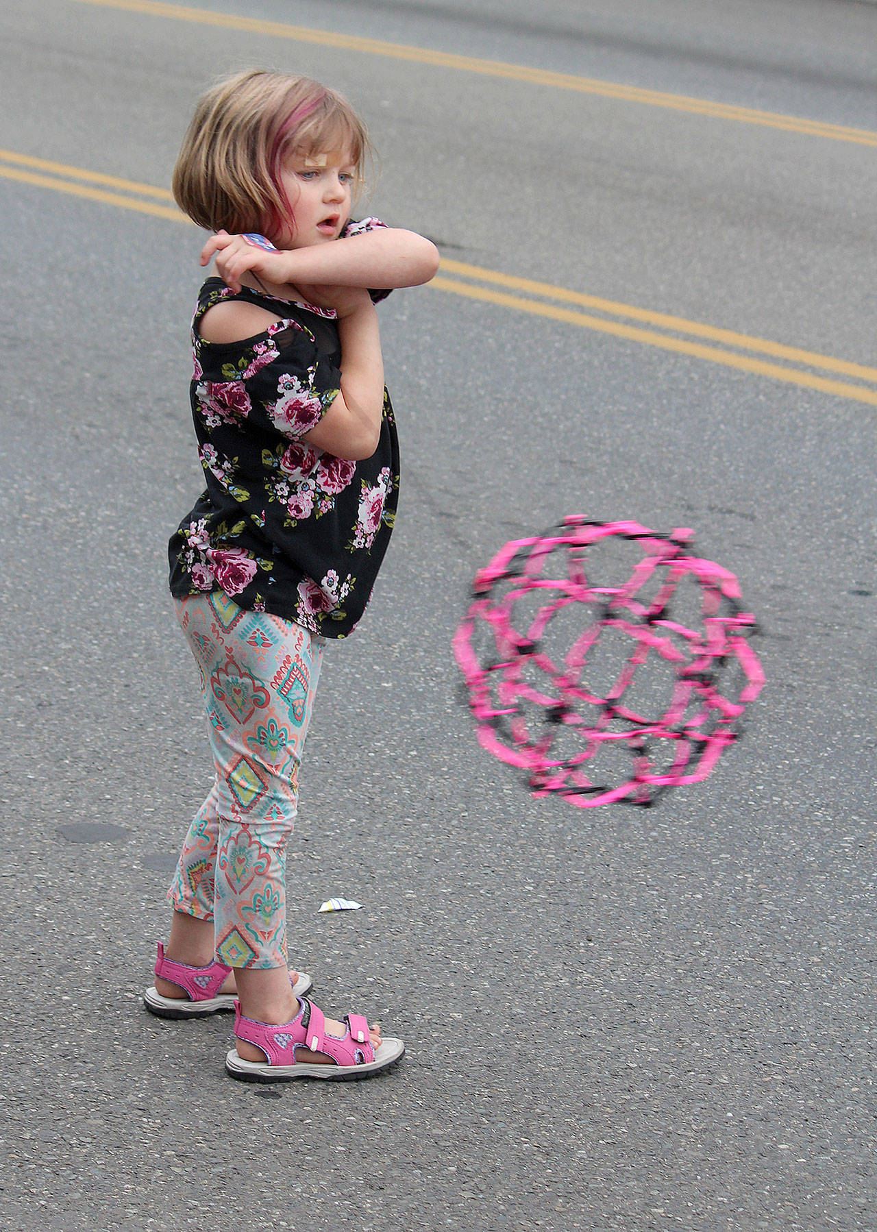 This young parade watcher brought along her own crowd dazzler on the parade sidelines. (Bob Smith | Kitsap Daily News)