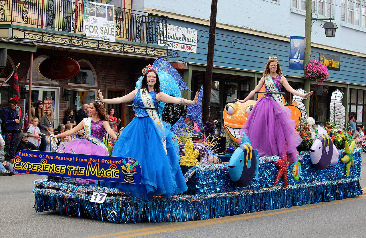 The Fathoms O’ Fun Festival float is graced by members of the Royalty Court: (from left) Senior Princess Maria Hoyt; Queen Tamara Medal; and Senior Princess Paige Hoffsommer. (Bob Smith | Kitsap Daily News)