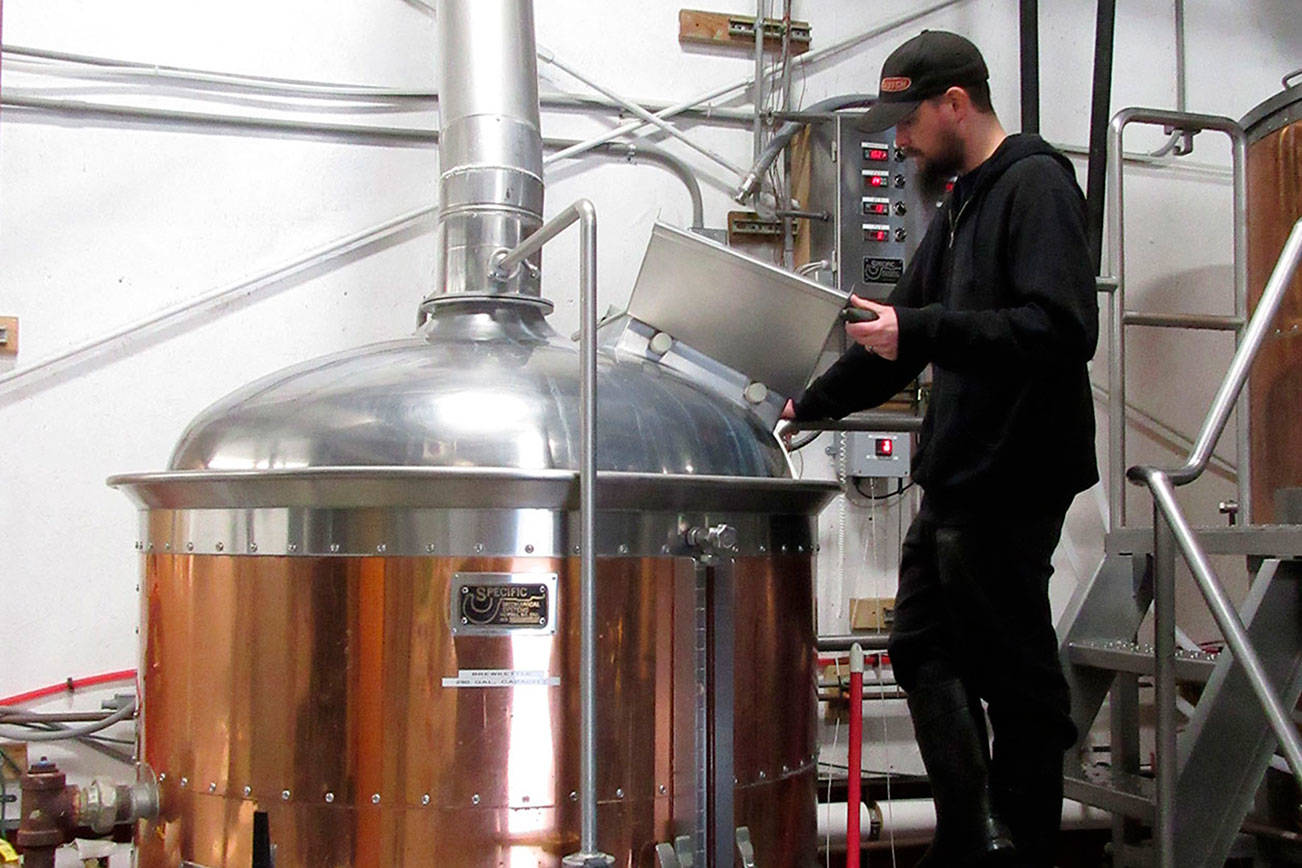 Jon Jump, assistant brewer at Rainy Daze Brewery in Poulsbo checks the tank in preparation for final hopping. Rainy Daze is one of many Kitsap County breweries participating in the Bremerton BrewFest July 20-21. (Terryl Asla/Kitsap News Group)