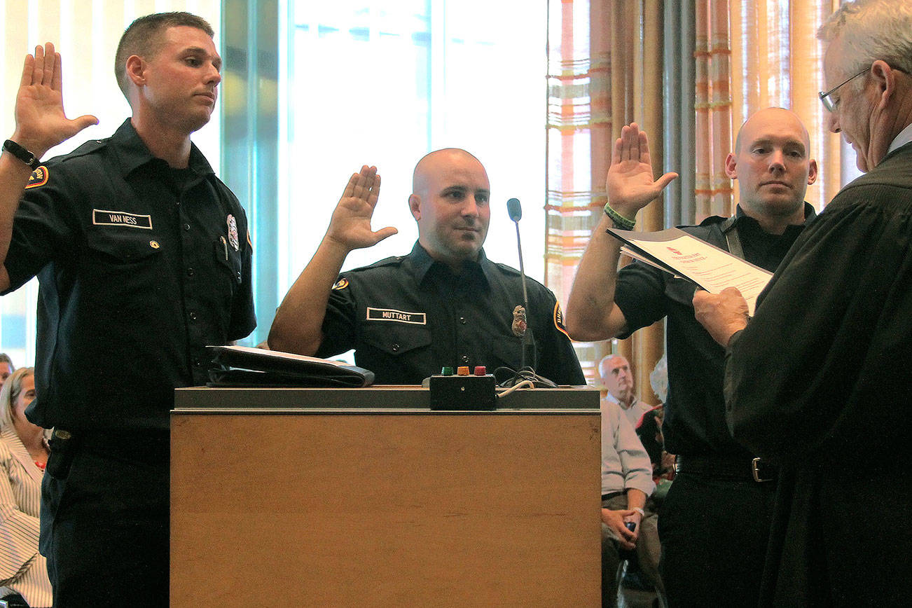 From left to right: Kurt Van Ness, Rickey Muttart and Evan Markovich, Bremerton’s three newest firefighters, were sworn in on Wednesday July 18. Markovich and Muttart have been with the department since April and Van Ness was hired in June. (Mark Krulish/Kitsap News Group)