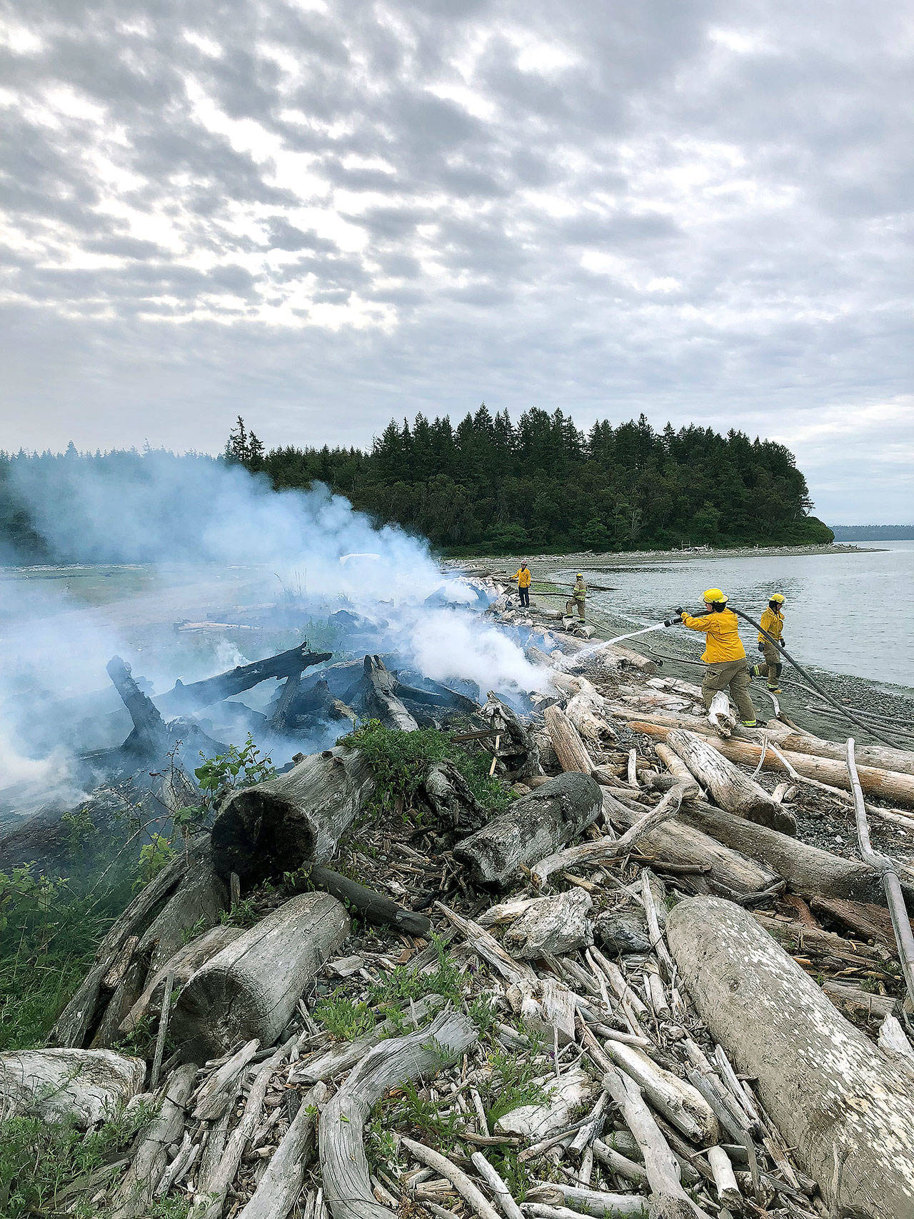 An incompletely-extinguished bonfire is thought to have sparked this May beach fire at the end of Shore Drive in Indianola. (Photo courtesy Michele Laboda, North Kitsap Fire and Rescue)
