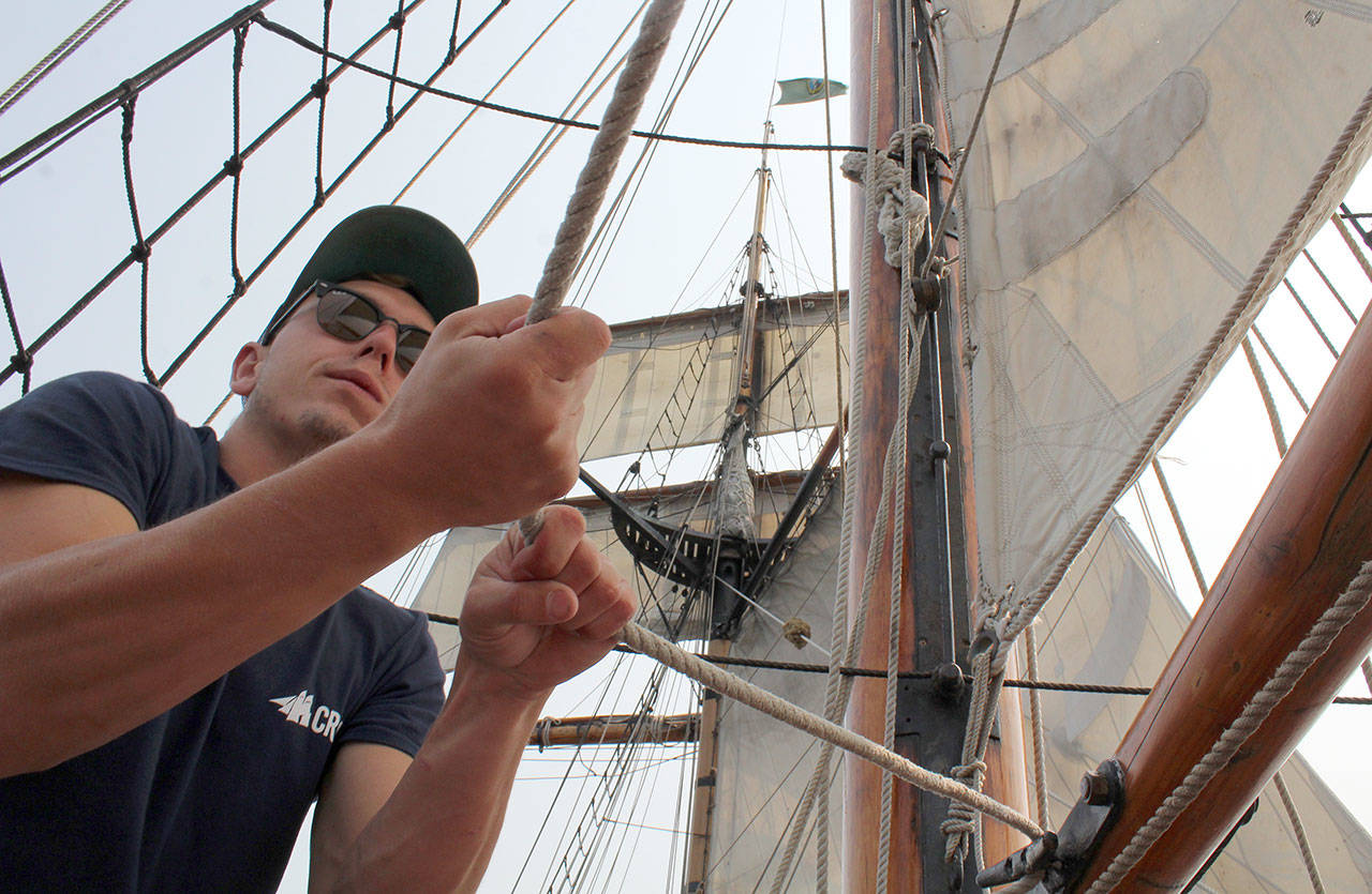 A crew member of Hawaiian Chieftain takes command of a mast line. (Bob Smith | Kitsap Daily News photo)