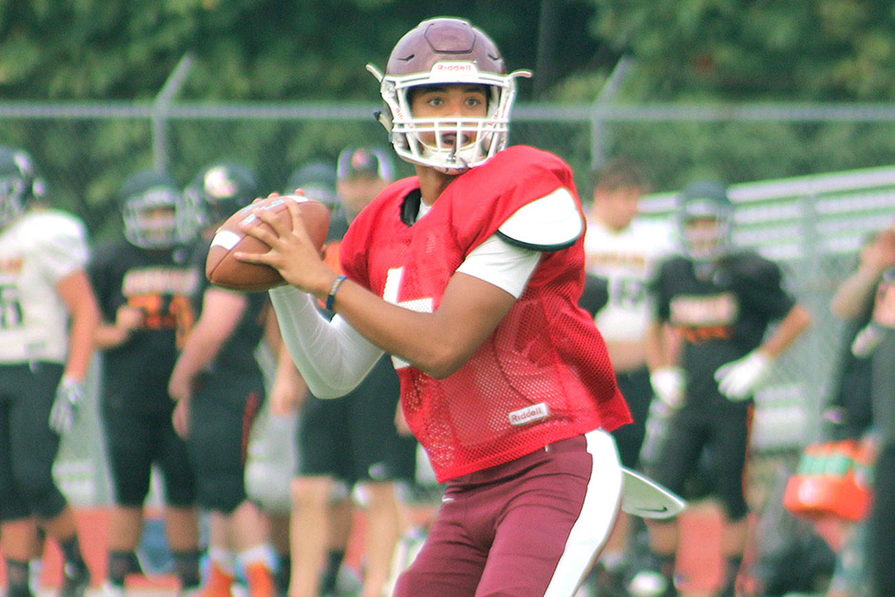 South Kitsap quarterback Hezekiah Moore looks down the field for an open receiver during a jamboree against Central Kitsap and Bremerton. (Mark Krulish/Kitsap News Group)