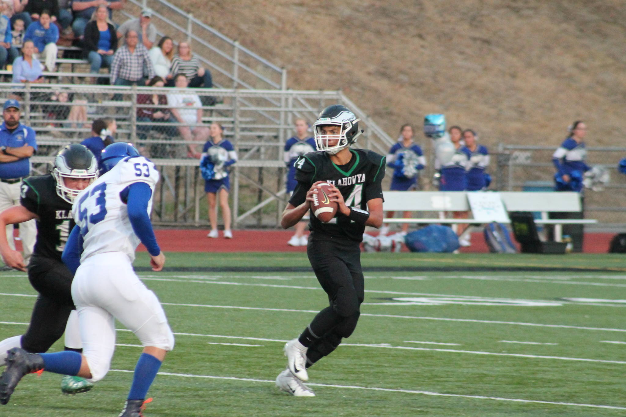 Klahowya quarterback John Hartford rolls to his left against North Mason. (Mark Krulish/Kitsap News Group)