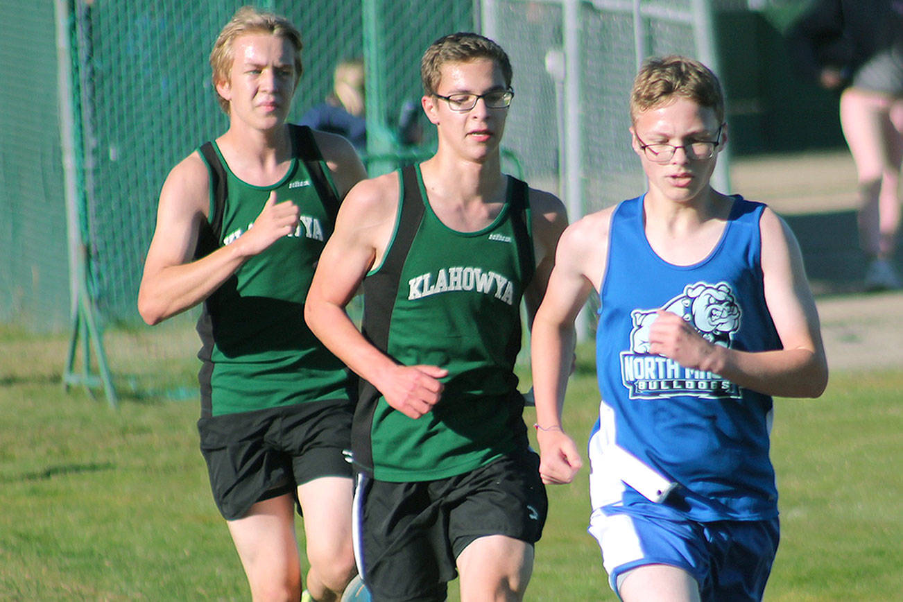 Klahowya’s Jaeden Ellis (left) and Alex Oathout (middle) chase North Mason’s Noah Hasselblad. (Mark Krulish/Kitsap News Group)