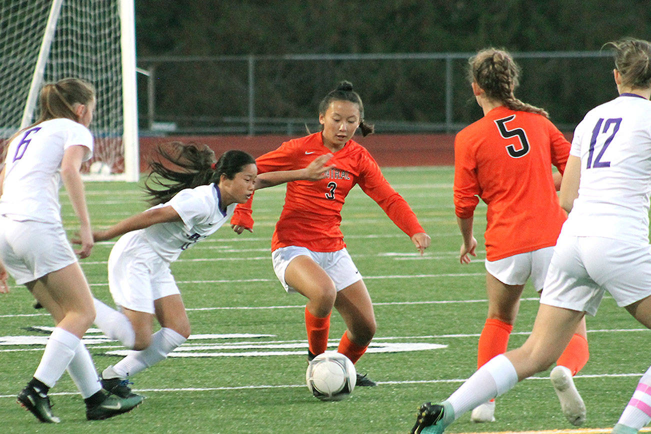 Ailin Zhang, one of two freshmen starting at forward for Central Kitsap, tries to dribble through the North Thurston midfield during her team’s 1-0 win on Sept. 27. (Mark Krulish/Kitsap News Group)