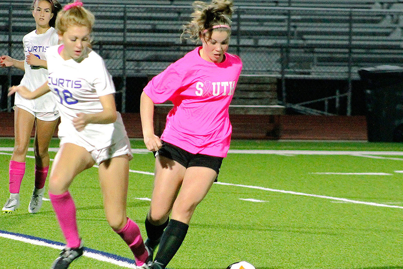 South Kitsap midfielder Sierrah VanGesen slips by a Curtis defender in her team’s 1-0 victory. (Mark Krulish/Kitsap News Group)