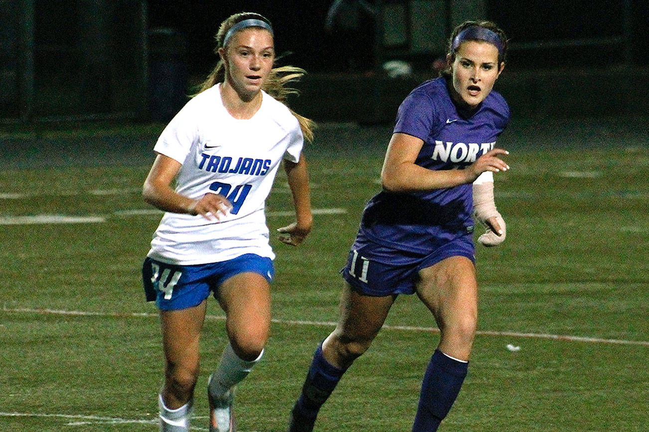 North Kitsap’s Jamison Jacobson tries to slip past Olympic’s Hanna Troy in an Oct. 18 match. (Mark Krulish/Kitsap News Group)