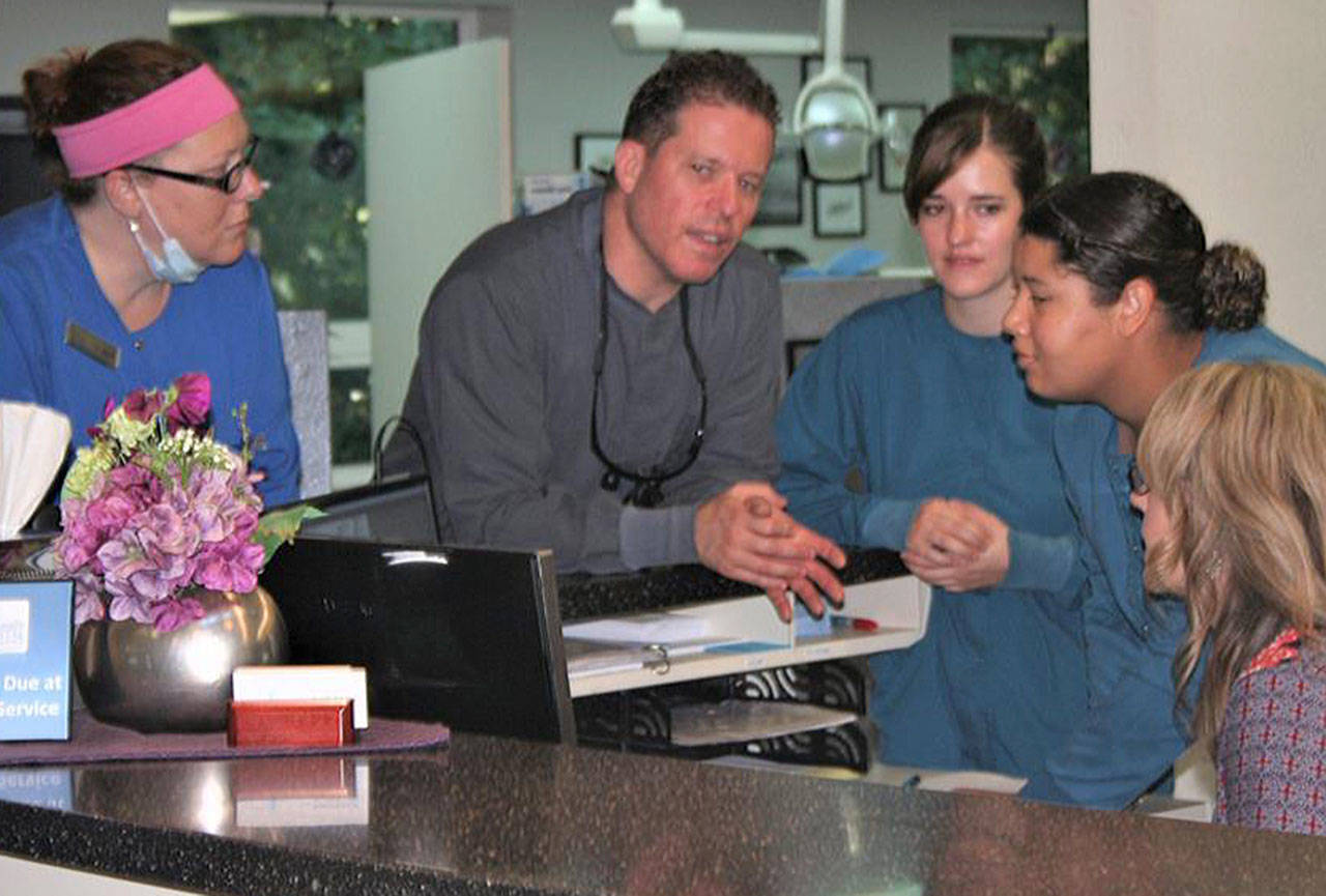 Dr. Ron Schoepflin (center) is surrounded by his dental team. (Contributed photo)