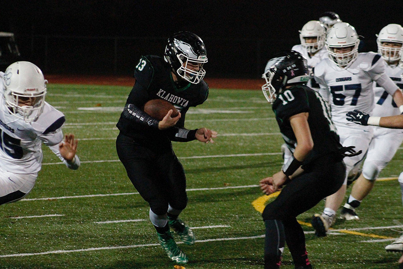 Hunter Wallis looks for a hole in the Cascade Christian defense in Thursday night’s 44-28 loss. (Mark Krulish/Kitsap News Group)