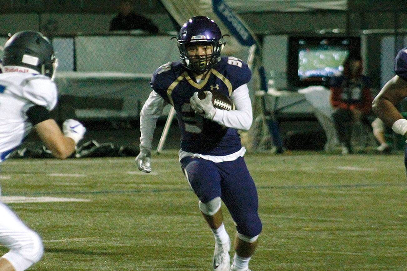 Clayton Williams rushes to the edge during his team’s 60-19 win over Olympic. (Mark Krulish/Kitsap News Group)