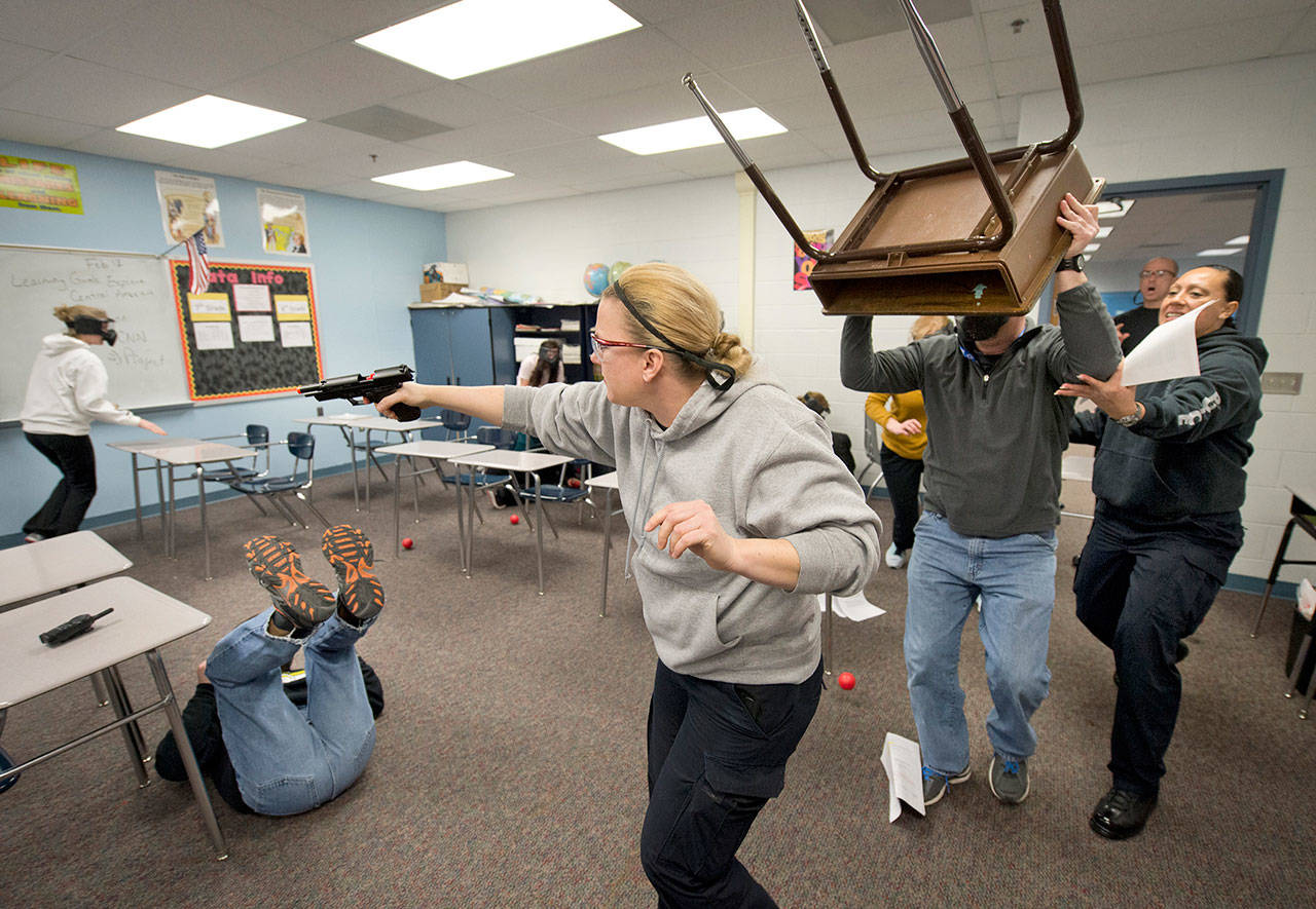 In this exercise, participants practice using any means available to fight off a shooter. (Republic of Buzz photo)