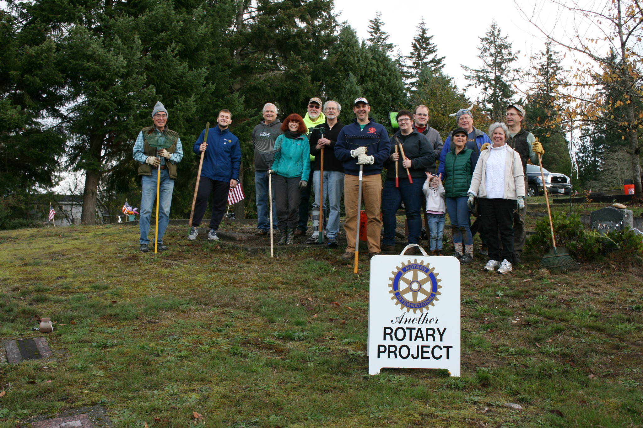 Volunteers with Poulsbo-North Kitsap Rotary Club pose for a photo during a cemetery cleanup on Nov. 10.