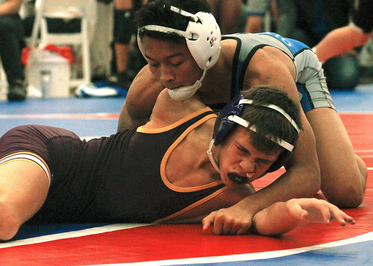 Olympic’s Anjelo Pangelinan wrestles his counterpart from Wenatchee in the fifth place dual. Pangelinan scored two pins and a technical fall in his matches. (Mark Krulish/Kitsap News Group)