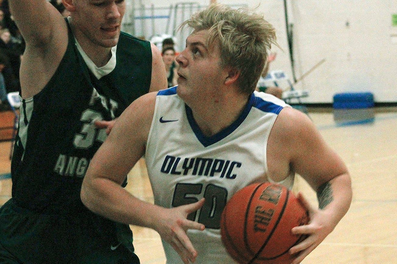 Greg Brehmer (50) tries to get by Liam Clark of Port Angeles in an 83-52 loss on Dec. 18. (Mark Krulish/Kitsap News Group)