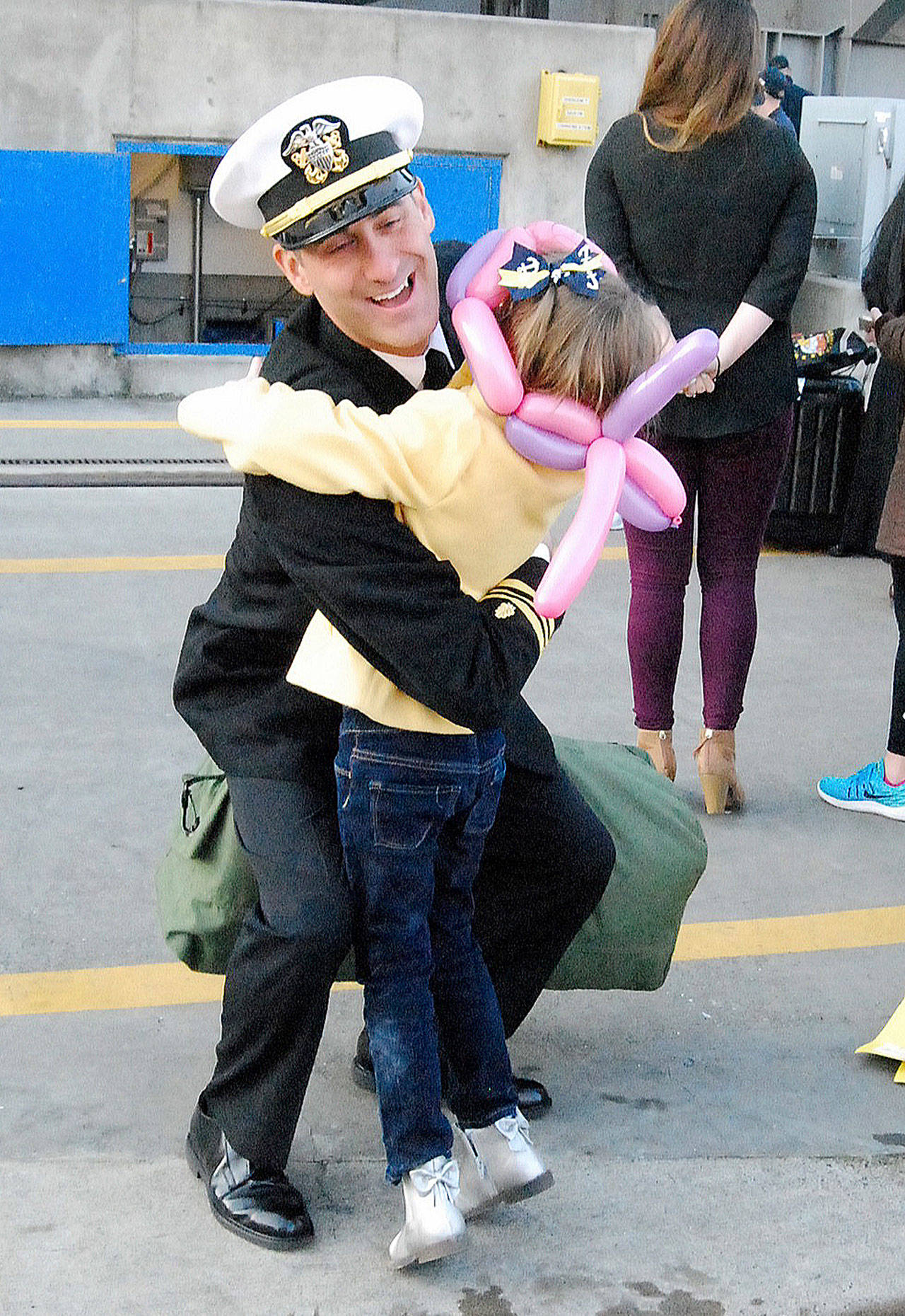 This Nimitz daddy gives a hug to one of his tearful daughters.