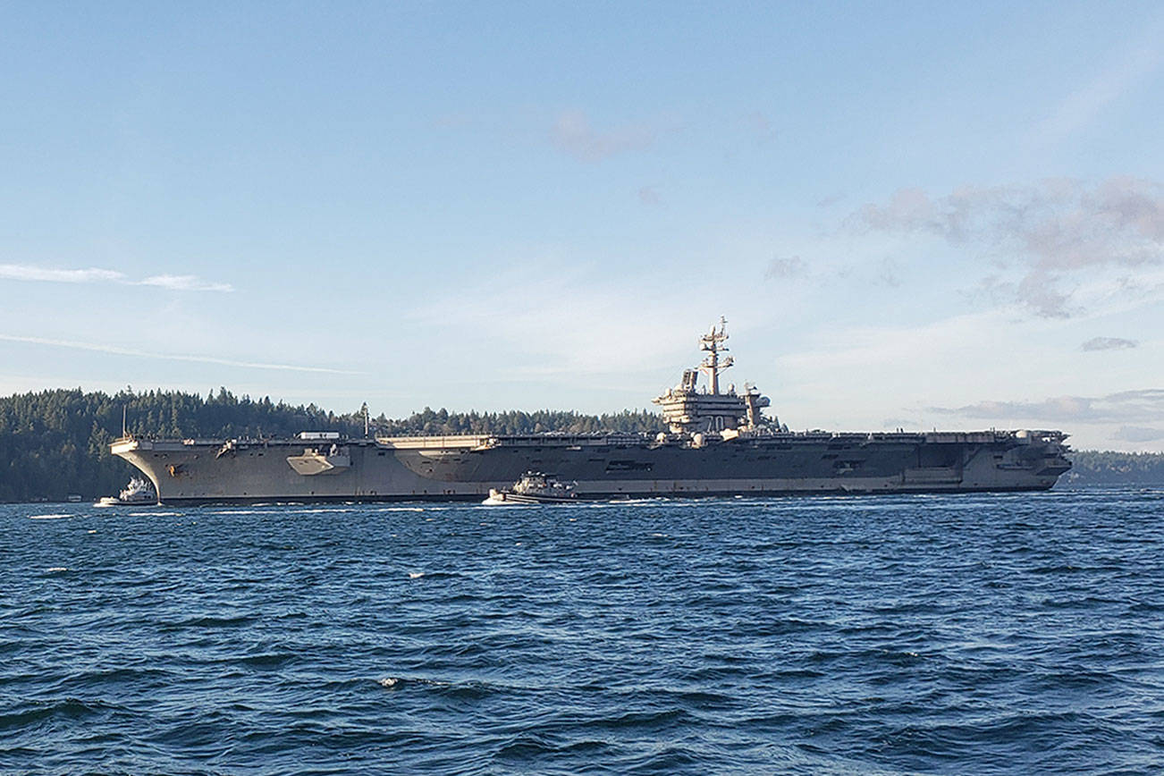 Aircraft carrier docks in Bremerton