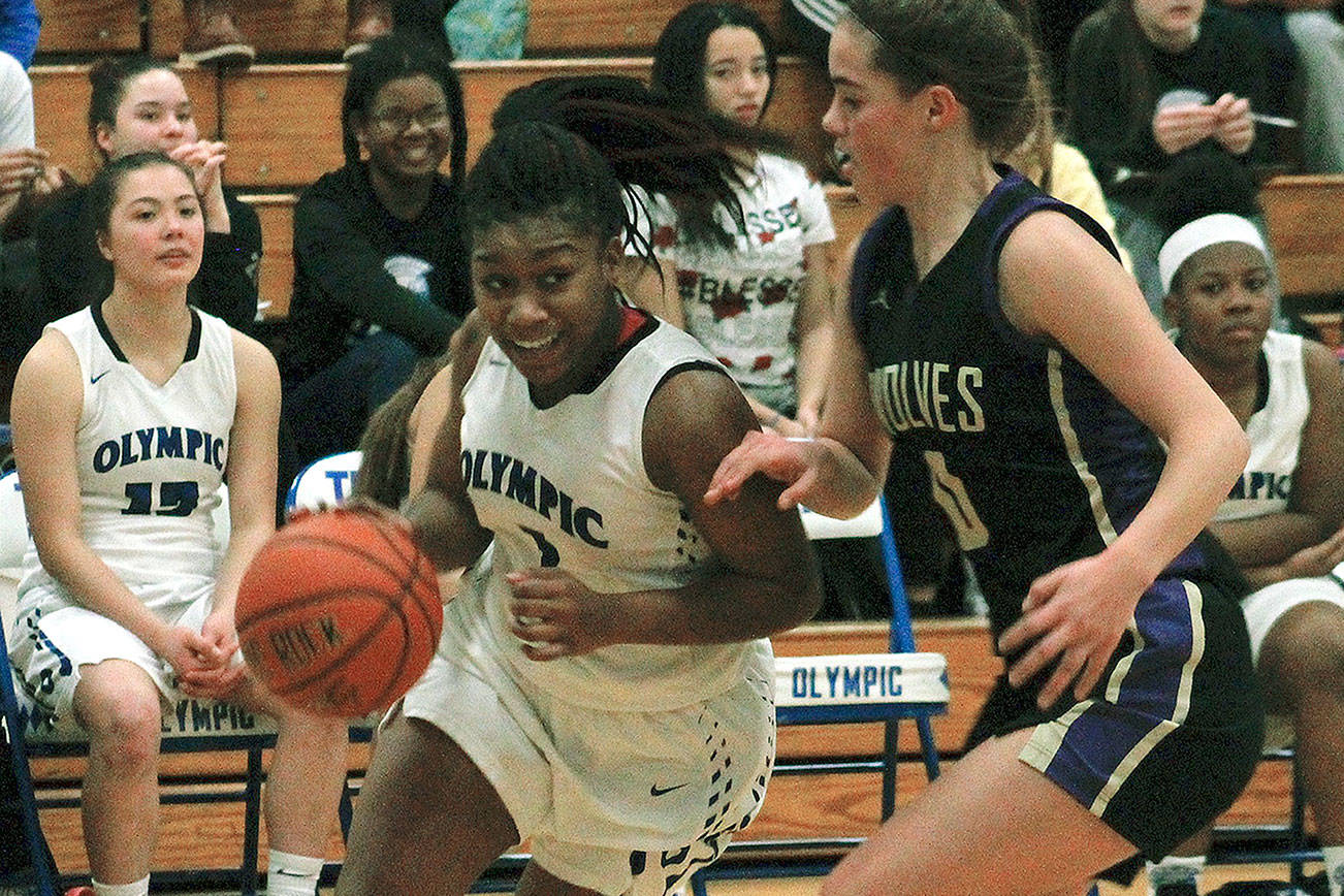 Olympic guard Jakyiiah Willis drives the baseline against Sequim in her team’s 49-45 victory. (Mark Krulish/Kitsap News Group)