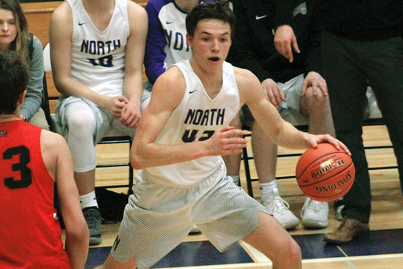 Jamo Moore looks for an opening in the paint during his team’s 59-51 win over Clarkston. (Mark Krulish/Kitsap News Group)