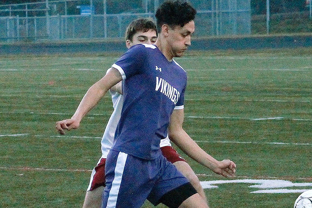 North Kitsap senior Joey Gore tries to flag down a pass and get past a Kingston defender in his team’s 1-0 victory. (Mark Krulish/Kitsap News Group)