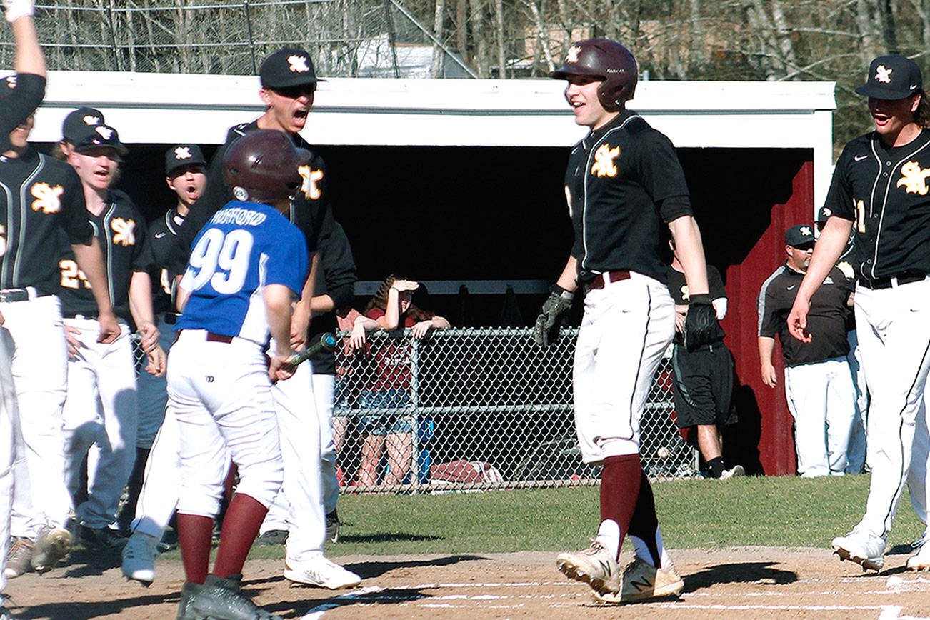 Sam Canton comes to the plate to celebrate after hitting a leadoff home run against Graham-Kapowsin. (Mark Krulish/Kitsap News Group)