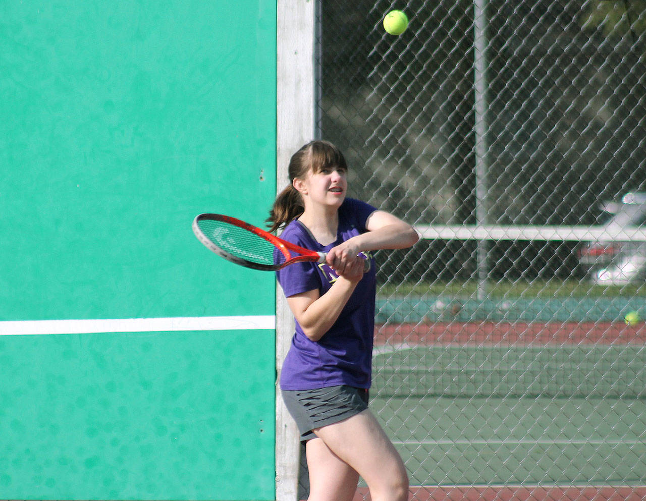Grace Coleman goes to her backhand during a doubles match against Klahowya. (Mark Krulish/Kitsap News Group)