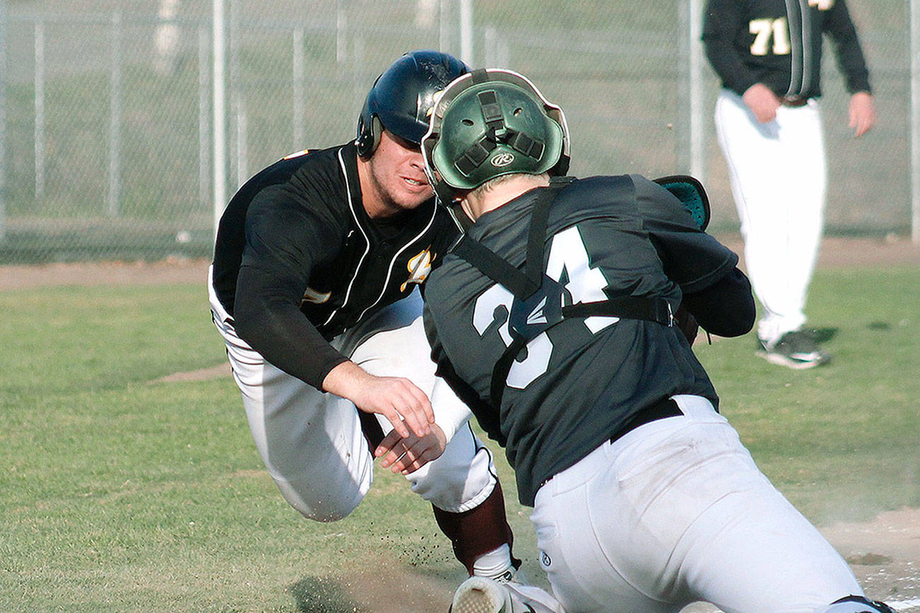 Jacob Duarte dives for the plate in the seventh inning against Emerald Ridge, but a good throw resulted in an out. (Mark Krulish/Kitsap News Group)