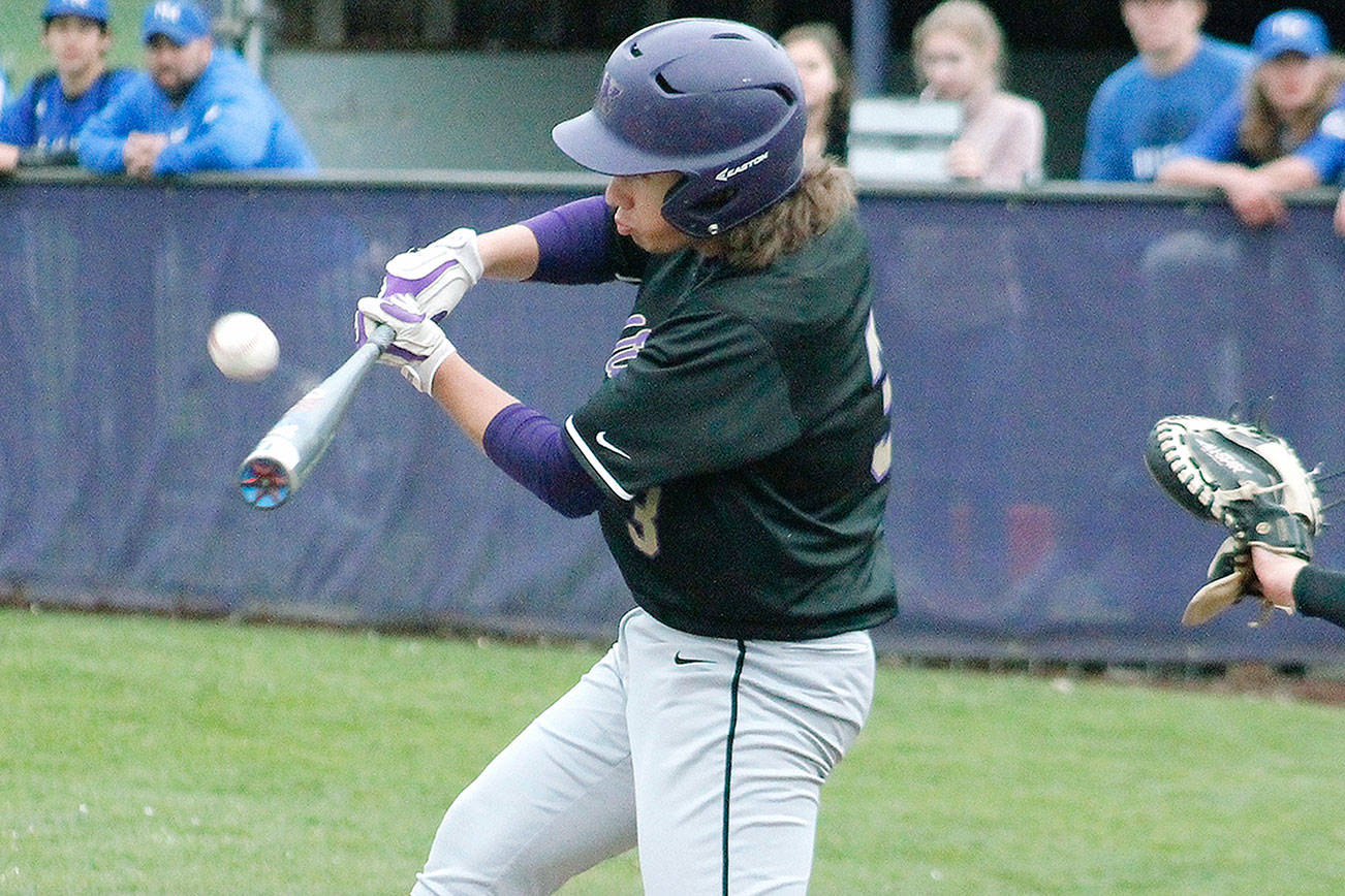 Josh Fisher drives a ball the opposite way in North Kitsap’s win over North Mason. (Mark Krulish/Kitsap News Group)