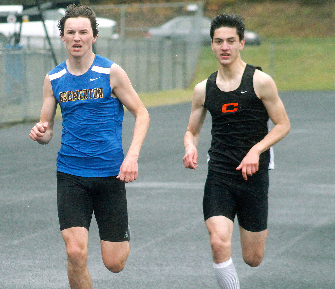 Bremerton’s Erik Anderson and Central Kitsap’s Louis Gannon run side-by-side during the 800. (Mark Krulish/Kitsap News Group)