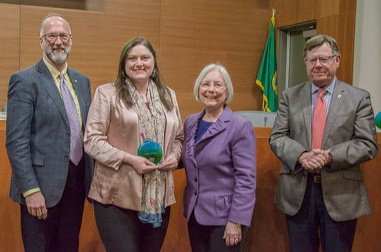 Sustainability advocate Paisley Gallagher (second from left) was nominated to be a 2019 Earth Day Award winner. Left to right: Kitsap County Commissioner Rob Gelder, Gallagher and commissioners Charlotte Garrido and Ed Wolfe. (Kitsap County photo)