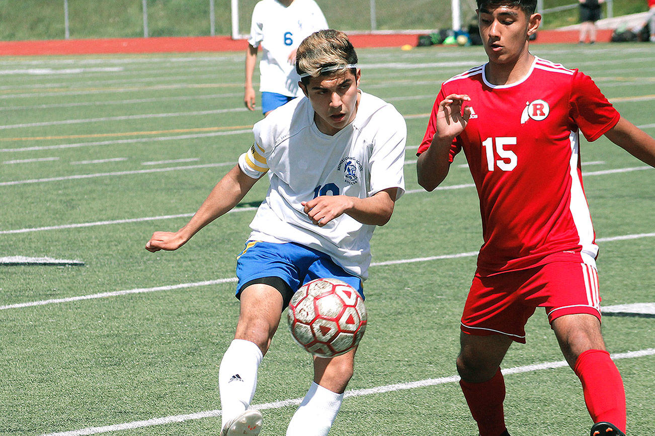 Bremerton’s Luis Clemen flicks a ball upfield against Renton in the first round of the 2A West Central District III tournament. (Mark Krulish/Kitsap News Group)