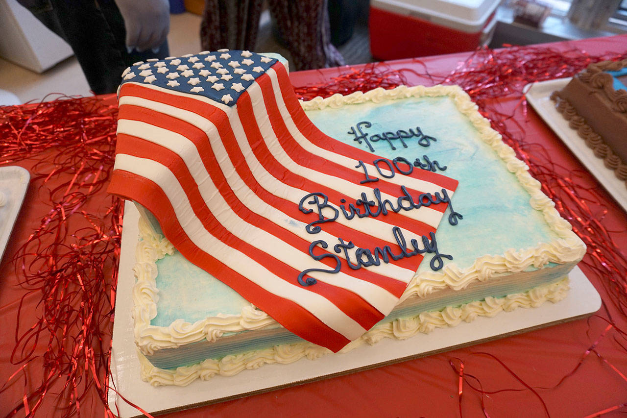 This brightly decorated birthday cake was one of three ready for slicing at the veteran’s birthday party. (Bob Smith | Kitsap Daily News)