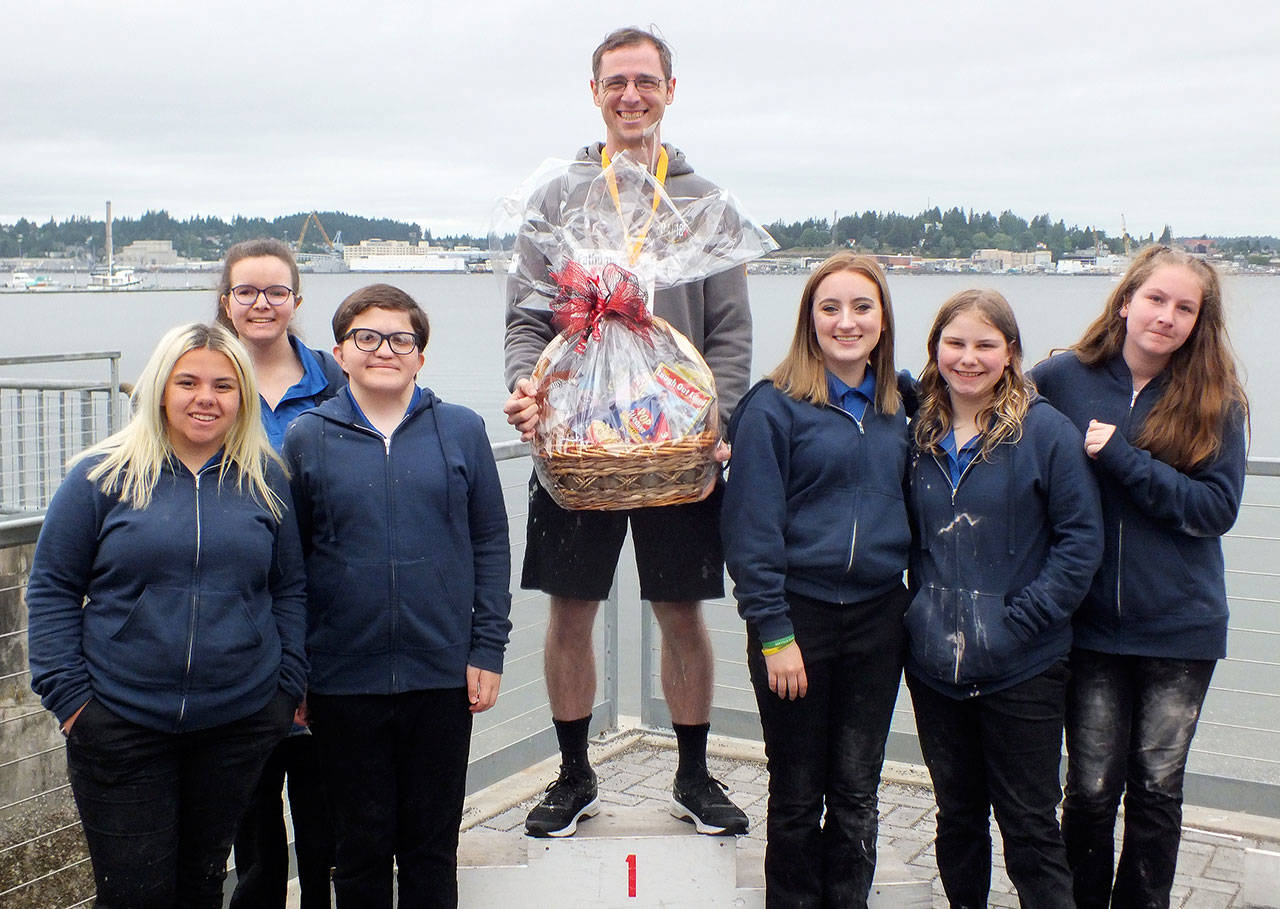 Joe Viviano (center with basket), was the top male finisher in the 2019 Seagull Splat 5K Run May 25 in Port Orchard. Surrounding Viviano are members of the Fathoms O’ Fun Royalty Court. (Submitted photo)