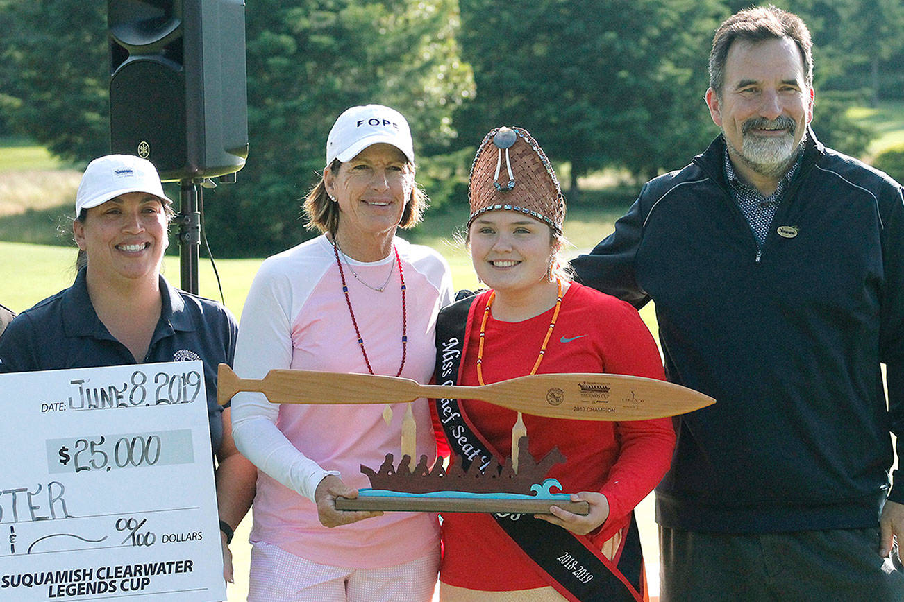 Juli Inkster, the winner of the 2019 Suquamish Clearwater Legends Cup is presented with the trophy and check by Irene Carper, COO of Port Madison Enterprises, Miss Chief Seattle Days Cassady Jackson and Suquamish Tribe Chairman Leonard Forsman. (Mark Krulish/Kitsap News Group)