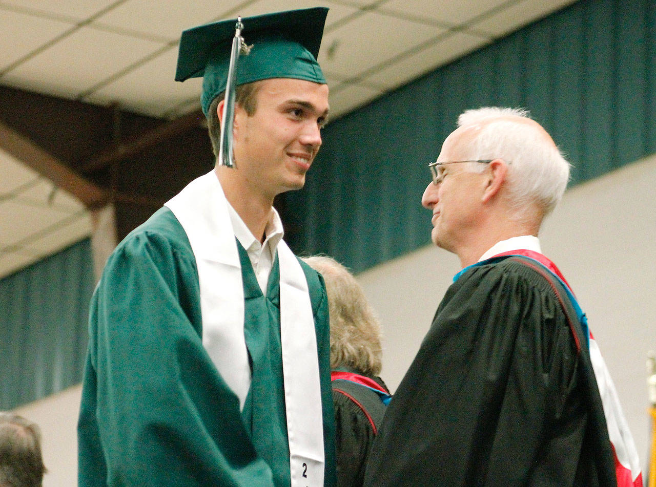 Graduates get their diploma and proceed out. (Mark Krulish/Kitsap News Group)