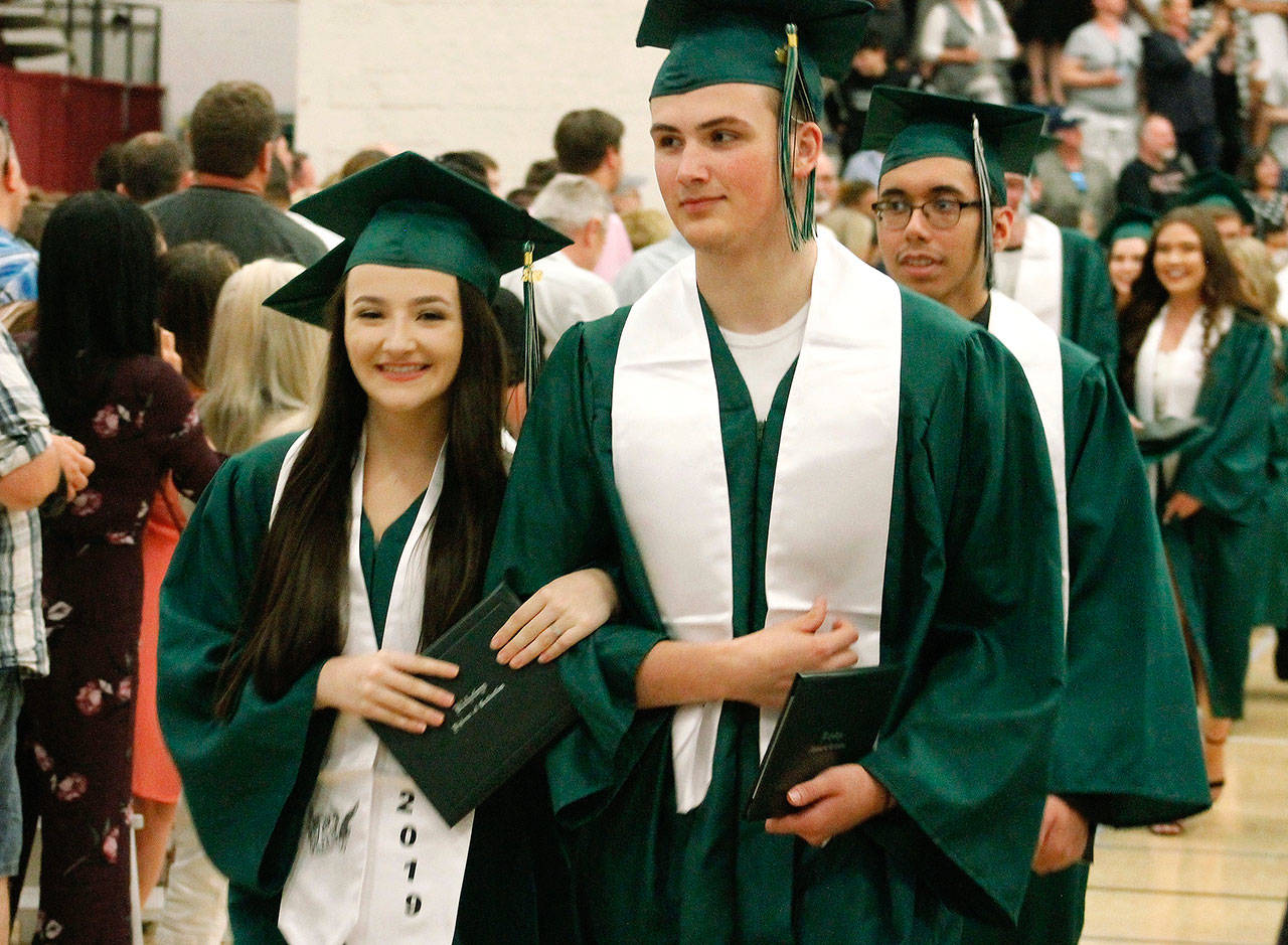 Graduates get their diploma and proceed out. (Mark Krulish/Kitsap News Group)