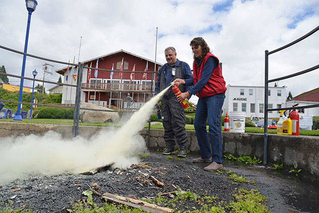 Craig Brown, administrative officer with U.S. Power Squadrons District 16 instructs participants in the proper use of a fire extinguisher during the Boating Safety Day event in Poulsbo on June 9, 2018. Courtesy Steve Erickson.
