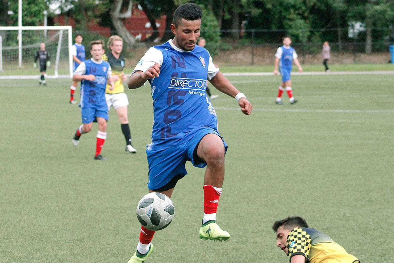 Former Kingston player Alex Hernandez evades a sliding tackle while playing for the Oly-Pen Force against the Vancouver Victory. (Mark Krulish/Kitsap News Group)