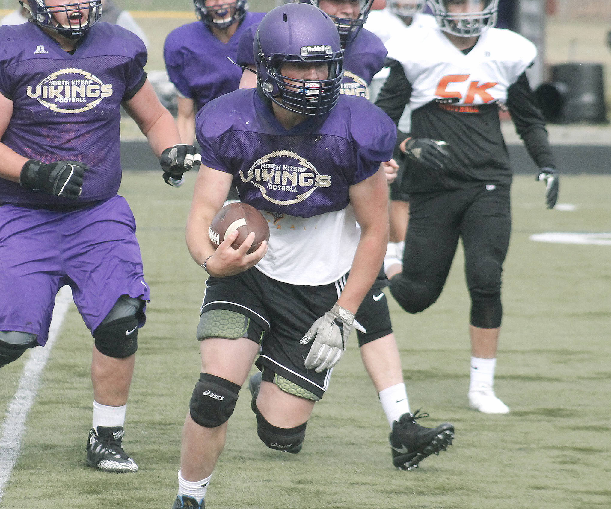 Cache Holmes carries the ball for North Kitsap at a recent scrimmage against Central Kitsap. (Mark Krulish/Kitsap News Group)