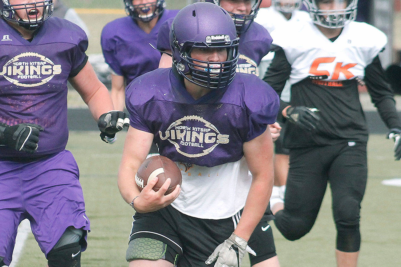 Cache Holmes carries the ball for North Kitsap at a recent scrimmage against Central Kitsap. (Mark Krulish/Kitsap News Group)