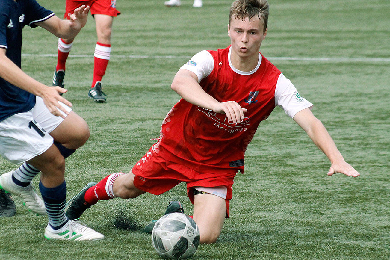 Mitchell Balmer gets taken down going for a loose ball against Spokane Shadow. (Mark Krulish/Kitsap News Group)