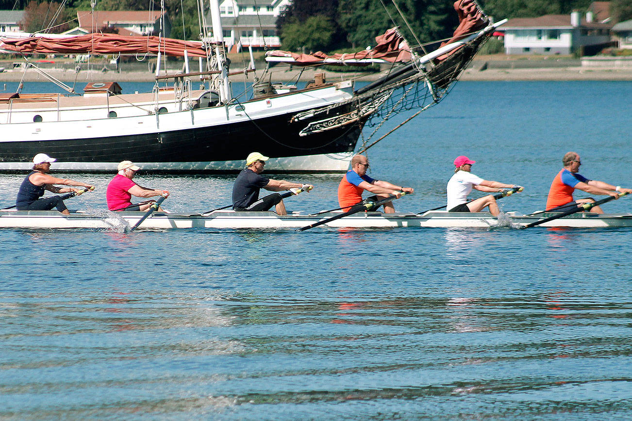 The “Thom” passes by Waterfront Park in Poulsbo. “Thom” was the winning eight in the inaugural Kitsap Invitational Masters Summer Scrimmage. (Mark Krulish/Kitsap News Group)