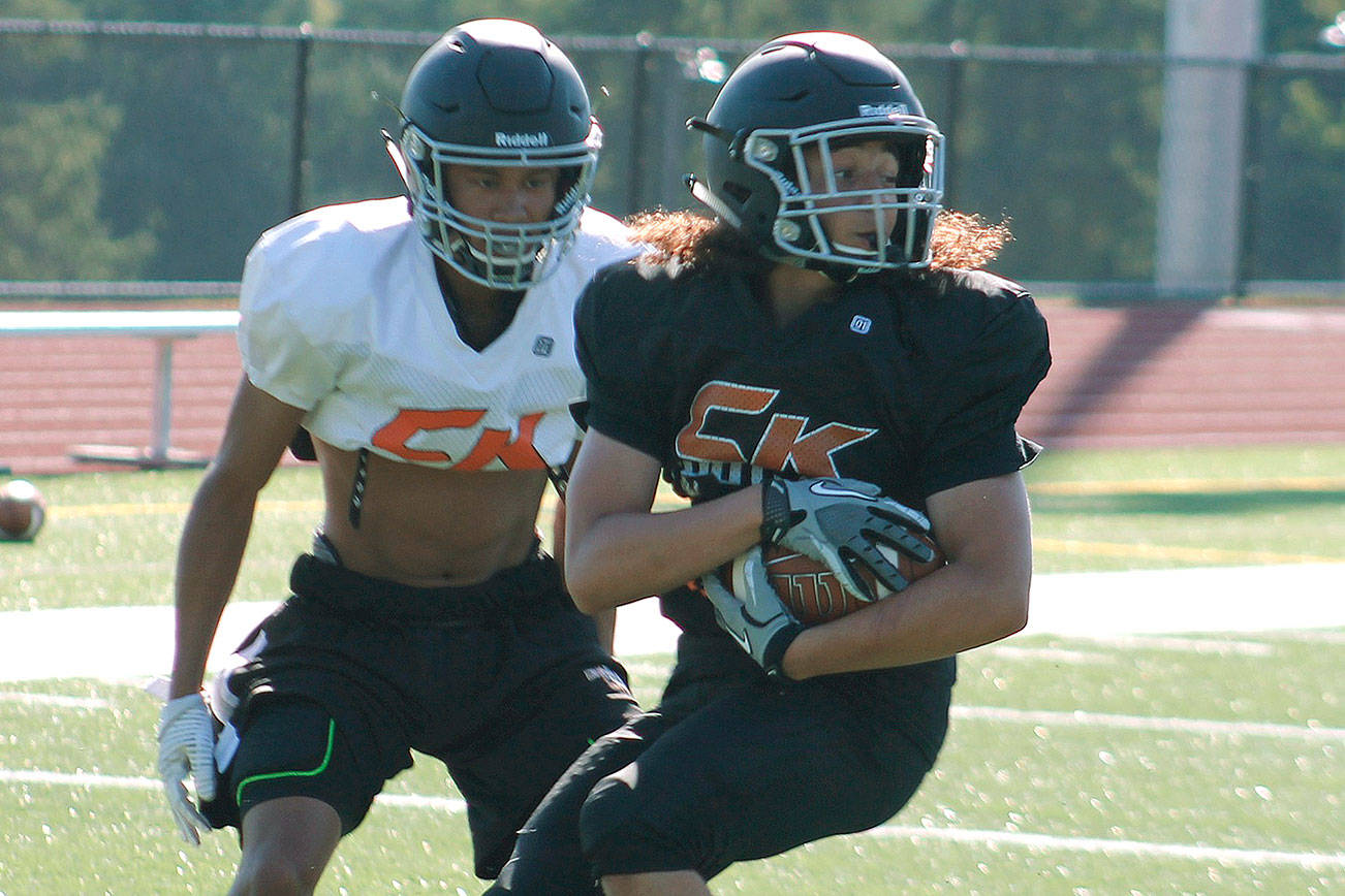 <em>Sophomore receiver Kalai Pasi catches a pass during a preseason practice. </em>                                Mark Krulish/Kitsap News Group