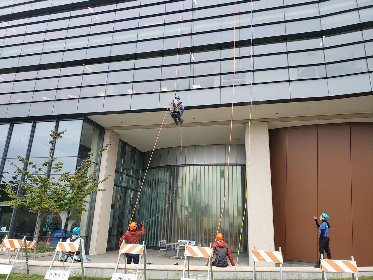 Elected officials, volunteers rappel down Norm Dicks Government Center for charity