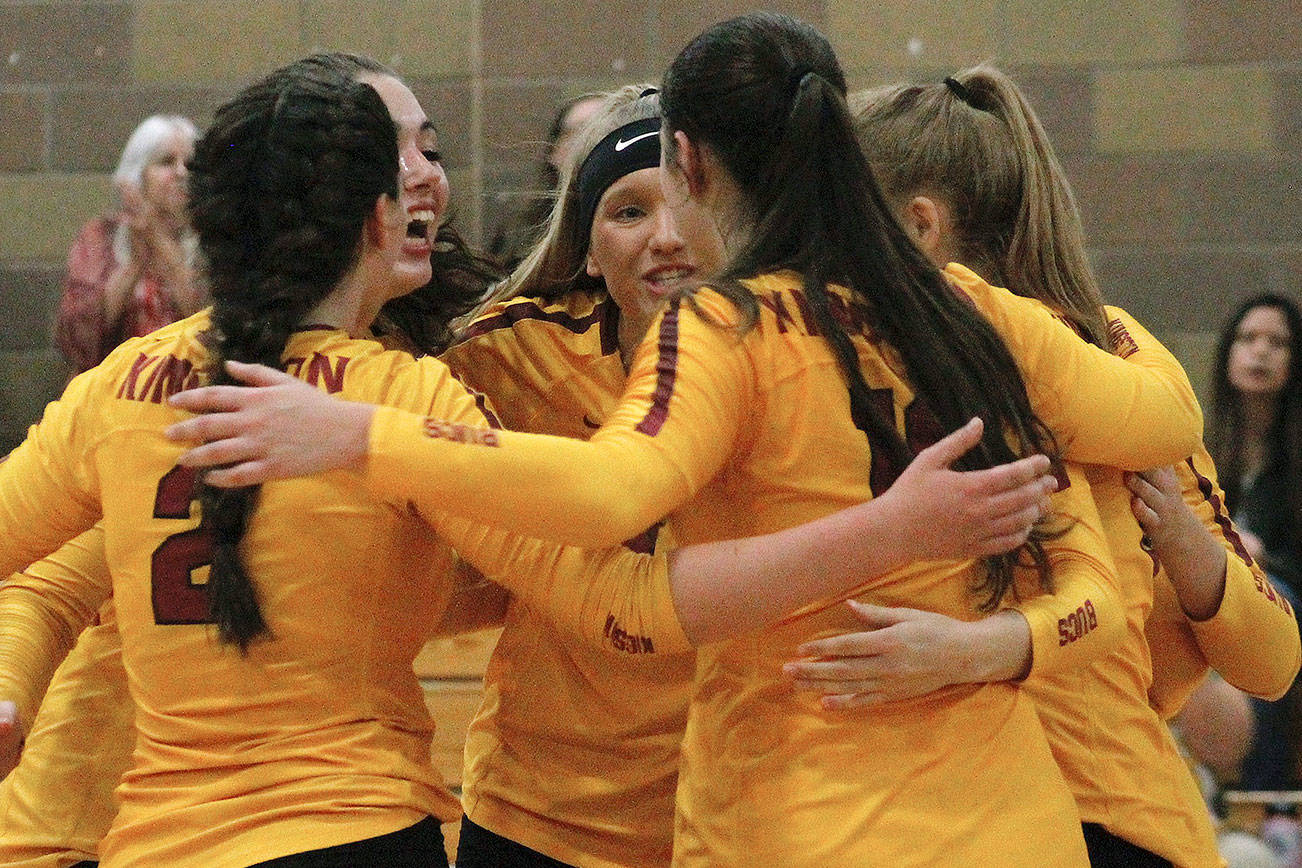The Buccaneers huddle up during a timeout late in set three just before defeating Bainbridge in their opening match. (Mark Krulish/Kitsap News Group)